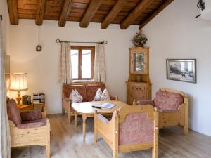 a living room with a table and chairs at Apartment Chesa Chanella 5 by Interhome in La Punt-Chamues-ch