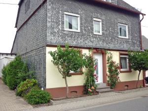 a house with flowers on the side of it at Holiday Home Haus Irmgard by Interhome in Haserich