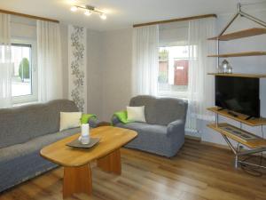 a living room with a couch and a table at Holiday Home Haus Irmgard by Interhome in Haserich