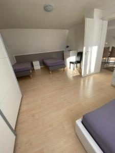 een woonkamer met paarse meubels en houten vloeren bij Ferienwohnungen Löhr in Koblenz