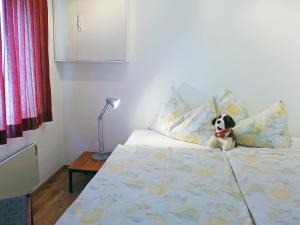 a stuffed dog sitting on top of a bed at Apartment Crap Milan by Interhome in Bivio