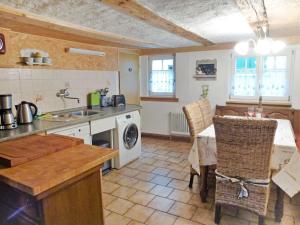 a kitchen with a sink and a table with a washing machine at Holiday Home Haus Schwärzel by Interhome in Neuried