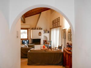 einen Torbogen im Wohnzimmer mit Sofa in der Unterkunft Apartment Chesa Prasüra 10 by Interhome in Sils Maria