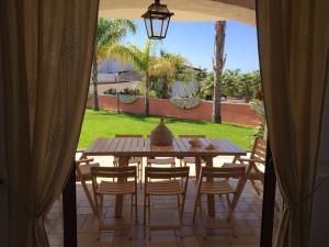 a wooden table and chairs on a patio at Villa Maris Capo Vaticano in Capo Vaticano