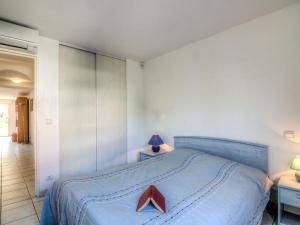 a bedroom with a blue bed with a red star on it at Apartment Le Magellan-1 by Interhome in Saint-Raphaël