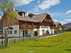 a large house with a fence in front of it at Apartment Top 7 by Interhome in Sankt Margarethen im Lungau