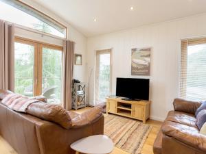 a living room with a couch and a television at 6 Lake View in Dobwalls