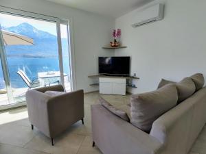 a living room with a couch and a television at Holiday Home Gelsomino - GLA125 by Interhome in Gera Lario
