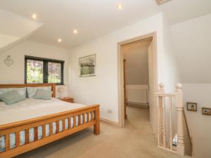 a bedroom with a large bed and a window at Pump House in Horam