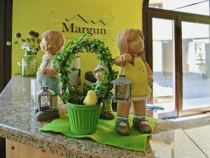 two dolls standing on a kitchen counter with lights at Studio Residenza Chesa Margun 34-4 by Interhome in Surlej