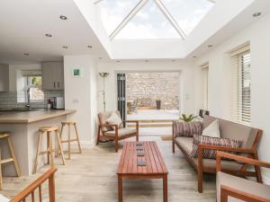 a kitchen and living room with a skylight at Charnwood Villa in Llandudno
