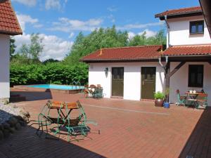a patio with chairs and a table and a house at Apartment Hiddensee by Interhome in Dargun +16 photos