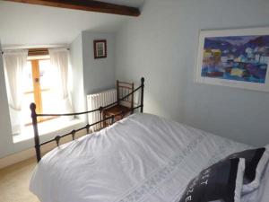 a bedroom with a bed and a window at The Old Stable in Abergavenny