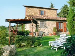 a stone house with two chairs and a gazebo at Holiday Home Vignole by Interhome in Panzano
