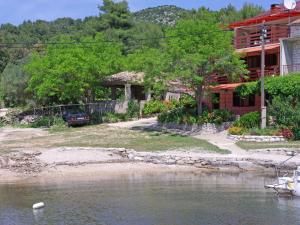 a house on the shore of a body of water at Apartment Šarenko-2 by Interhome in Vela Luka