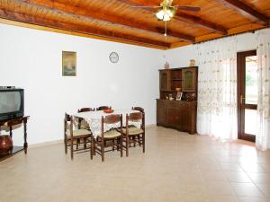 a dining room with a table and chairs and a tv at Apartment Šarenko-2 by Interhome in Vela Luka