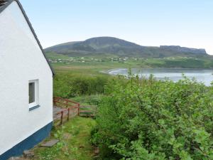 a house with a view of a body of water at Holiday Home Ewan's by Interhome in Staffin