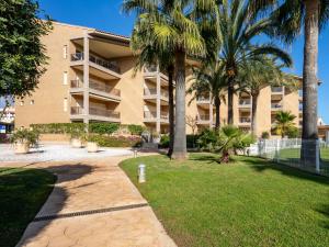 a apartment building with palm trees and a walkway at Apartment Marmara-4 by Interhome in Jávea