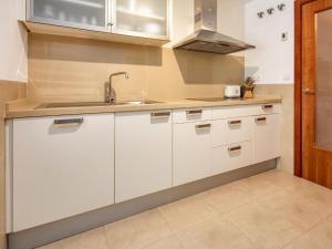a kitchen with white cabinets and a sink at Apartment Marmara by Interhome in Jávea
