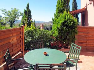 a green table and chairs on a patio at Apartment Archi - CET121 by Interhome in Luia