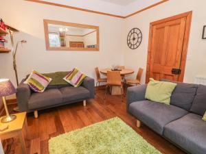 a living room with two couches and a table at 63 Rosetta Road in Peebles