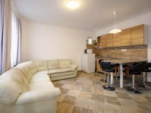 a living room with a couch and a table at Holiday Home Zsuzsi by Interhome in Balatonszemes