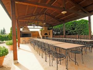 a large wooden table and chairs under a pavilion at Apartment Villastrada-2 by Interhome in Villastrada