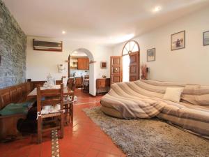 a bedroom with a large bed and a dining room at Villa Roberto by Interhome in Casa Gherardi