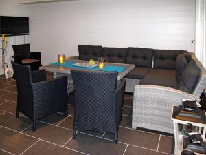 a living room with a couch and a table and chairs at Apartment Rorbuen by Interhome in Uggdal