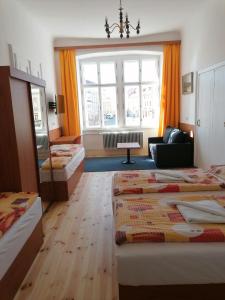 a hotel room with two beds and a window at Hotel Morava in Znojmo