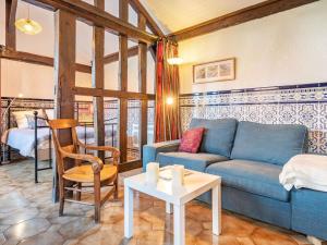 a living room with a blue couch and a table at Holiday Home La Poste by Interhome in Mimizan-Plage