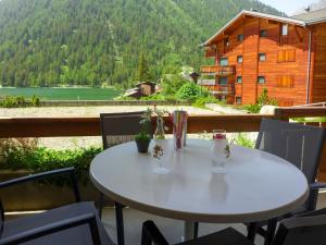 a table on a balcony with a view of a mountain at Apartment Parc C013 by Interhome in Champex
