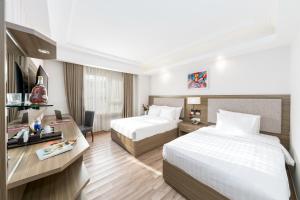 Postel nebo postele na pokoji v ubytování Golden Rose Hotel