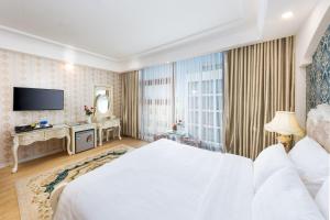 Postel nebo postele na pokoji v ubytování Golden Rose Hotel