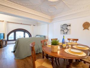 a dining room with a table and a bed at Apartment Reine Victoria by Interhome in Biarritz