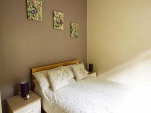 a bedroom with a bed and two pictures on the wall at South Lodge in Staveley