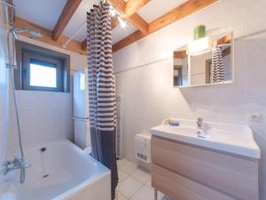 a bathroom with a sink and a toilet and a tub at Holiday Home New Village Park-3 by Interhome in Bredene