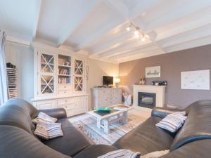 a living room with a couch and a fireplace at Holiday Home New Village Park-3 by Interhome in Bredene