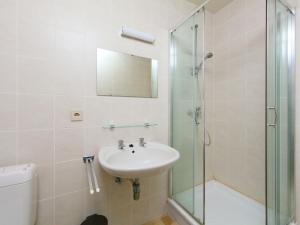 een badkamer met een wastafel en een glazen douche bij Apartment Residentie Astrid-8 by Interhome in Bredene