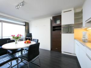 a kitchen and dining room with a table and chairs at Studio Studio met garage by Interhome in Bredene +8 photos