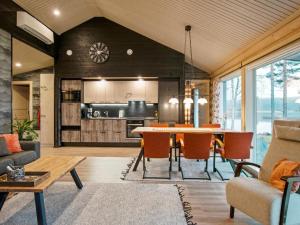 a kitchen and living room with a table and chairs at Holiday Home Mäntyranta by Interhome in Suninsalmi