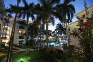 a large building with palm trees and palm trees at The Royal Cancun - All Suites Resort in Cancún