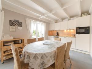 a kitchen and dining room with a table and chairs at Holiday Home Vissershuisje 09-01 by Interhome in Bredene