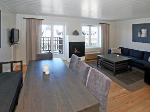a living room with a table and a couch at Apartment Havsdalsgrenda by Interhome in Geilo +15 photos