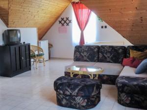 een woonkamer met een bank en een tafel bij Holiday Home Antal by Interhome in Balatonalmádi