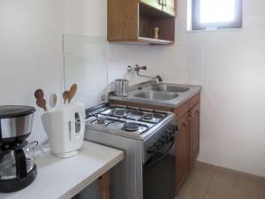 a small kitchen with a stove and a sink at Holiday Home Antal by Interhome in Balatonalmádi