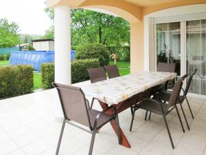 a dining table and chairs on a patio at Holiday Home Pentaller - SZA341 by Interhome in Balatonföldvár