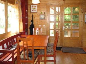 a dining room with a wooden table and chairs at Holiday Home Hajnal - FOD146 by Interhome in Fonyód