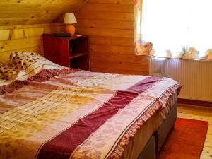 a bedroom with a bed with a quilt on it at Holiday Home Hajnal - FOD146 by Interhome in Fonyód