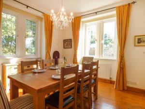 a dining room with a wooden table and chairs at The Old School House in Launceston